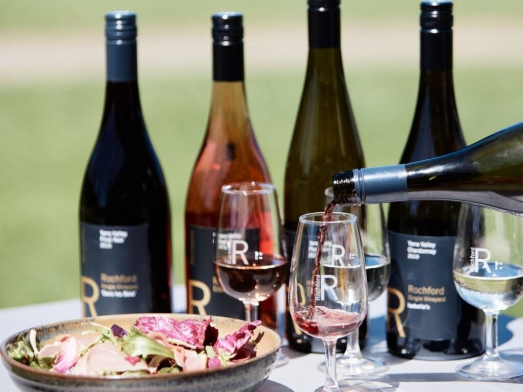 Winery Day Tours vineyard view | Adelaide Hills wine tasting tour | Barossa Valley wine and food experience | McLaren Vale coastal vineyard | Yarra Valley winery day trip | Mornington Peninsula vineyard lunch | Small group wine tasting tour | Luxury winery tour experience | Couples enjoying wine at vineyard | Corporate winery event tour